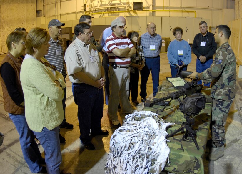 MINOT AIR FORCE BASE, N.D. -- Staff Sgt. Leonard Meadows, 91st Security Forces Group tactical response force team leader, explains sniper techniques and specifications of equipment to members of the League of Cities during the TRF demonstration stop of their tour Sept. 25 here. Group tours such as these continue the growing friendship between Minot AFB and its surrounding communities all across the state. (U.S. Air Force photo by Airman 1st Class Benjamin Stratton)