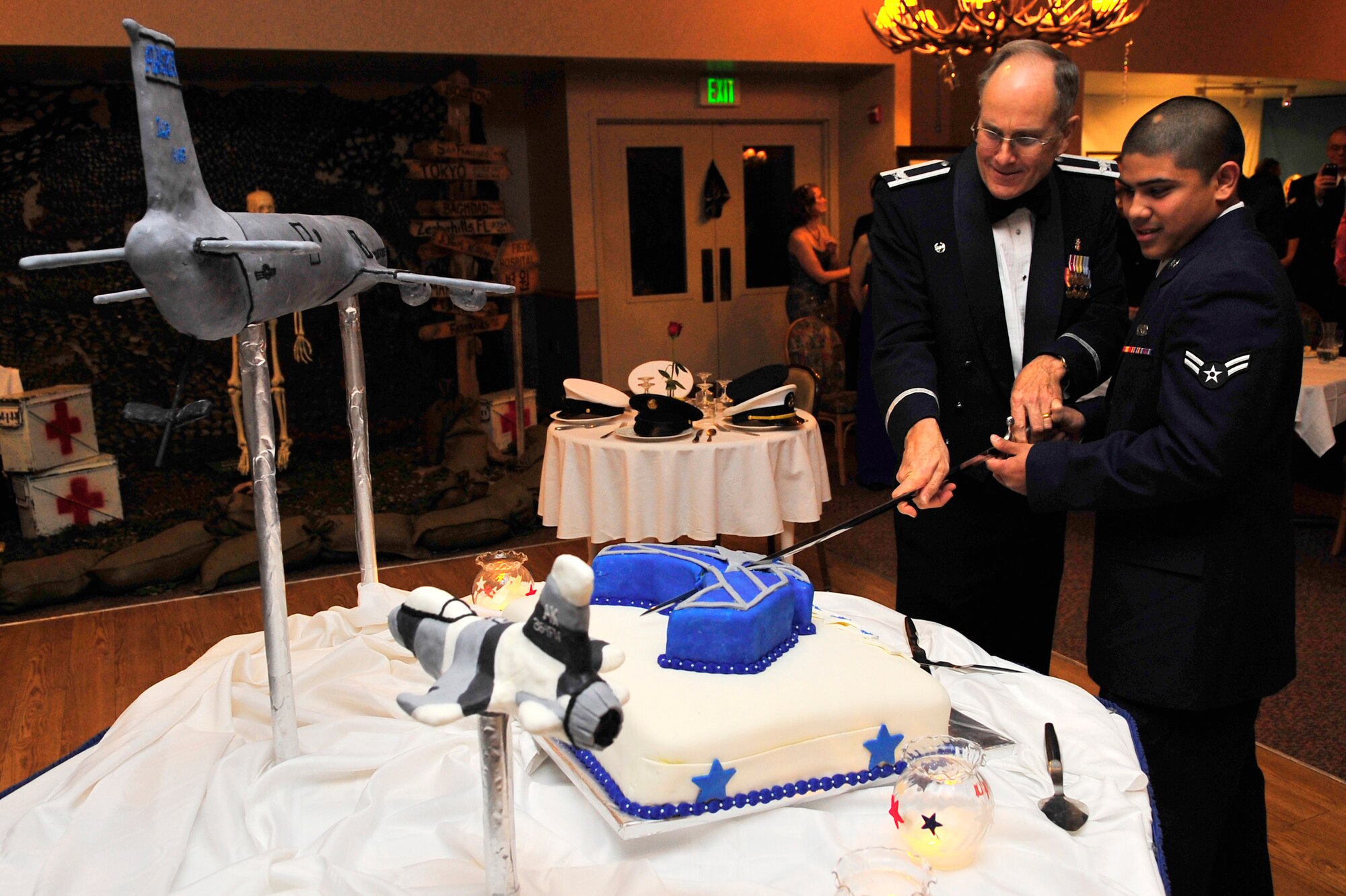 Col. Howard Hayes and Airman 1st Class Ross Ebanez cut the cake during the Air Force's 62nd Birthday celebration at the Yukon Club Sept. 25, 2009, Eielson Air Force Base, Alaska. As part of Air Force tradition, the cake is cut by the oldest and youngest Airmen present. Colonel Hayes is the 354th Medical Group commander and Airman Ebanez is assigned to the 354th Maintenance Squadron. (U.S. Air Force photo/Staff Sgt. Christopher Boitz)