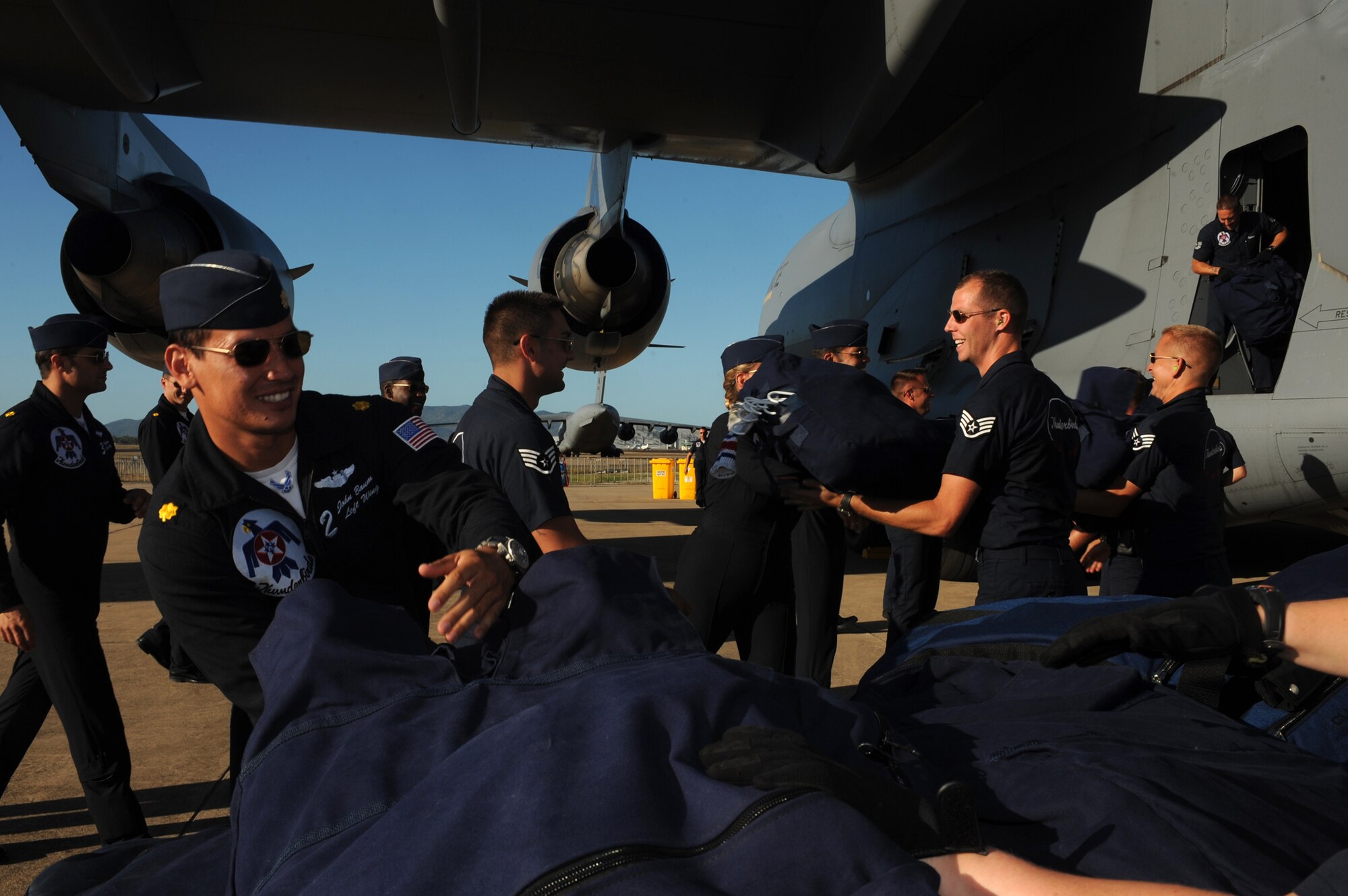 U.S. Air Force Thunderbirds team up to unload the final C-17 upon its arrival in Townsville, Australia, Sep. 21, in preparation for a weekend performance. (U.S. Air Force photo/Staff Sgt. Kristi Machado)
