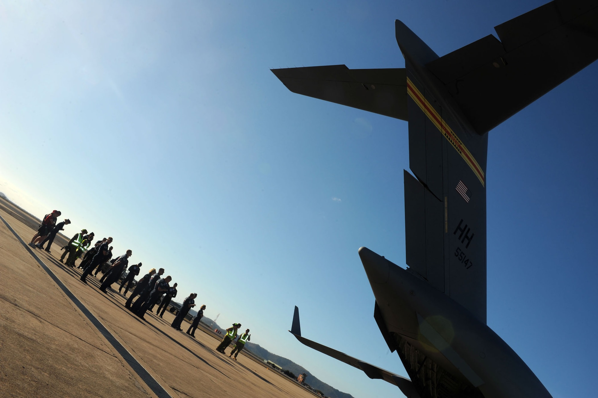 Members of the Australian Air Force and United States Air Force Thunderbirds await the arrival of the remaining Thunderbird crew, Sep. 21.  The Thunderbirds will be performing in Townsville, Australia. (U.S. Air Force photo/Staff Sgt. Kristi Machado)