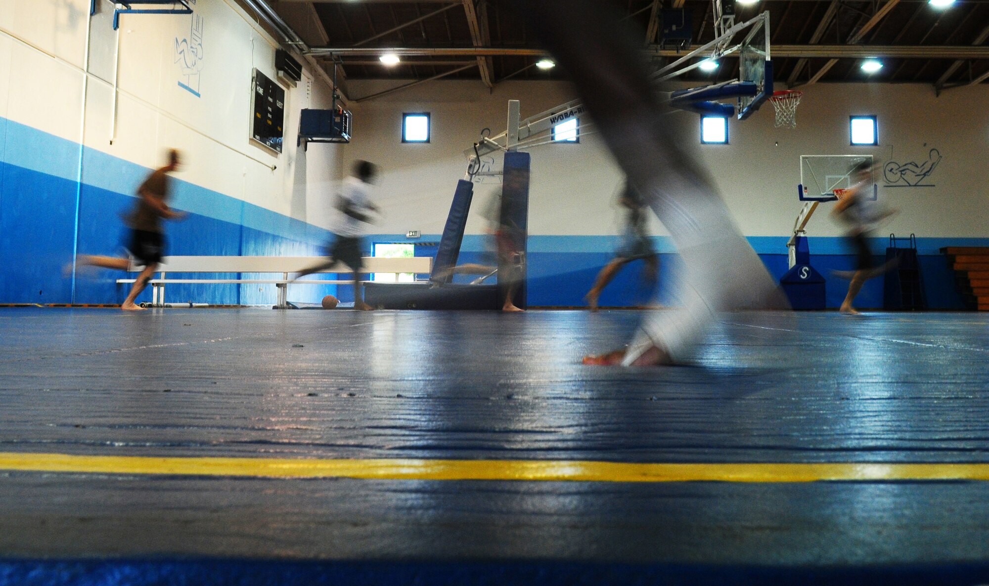 Members of team Ramstein warm up on the wrestling mats in preparation for a free lesson in Brazilian Jujitsu from a few of the world's best.  Ultimate Fighting Championship fighter Jason 'The Punisher' Lambert and World Extreme Cage fighting fighter Brian Michael Stann lead the grappling session on Ramstein Air Base, Germany, September 28th, 2009. (U.S. Air Force Photo by: Staff Sgt. Jocelyn Rich)