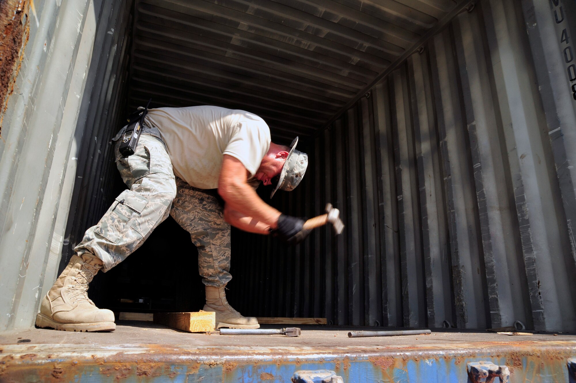 SOUTHWEST ASIA -Staff Sgt. LaWayne Rogers, 380th Expeditionary Logistics Readiness Squadron, swings a hammer to remove a wooden board used to hold a shipping palette in place here Sept. 29, 2009. Sergeant Rogers is deployed
from the 132nd Fighter Wing, Iowa, and grew up in Altoona, Iowa. (U.S. Air Force photo/Tech. Sgt. Charles Larkin Sr)
