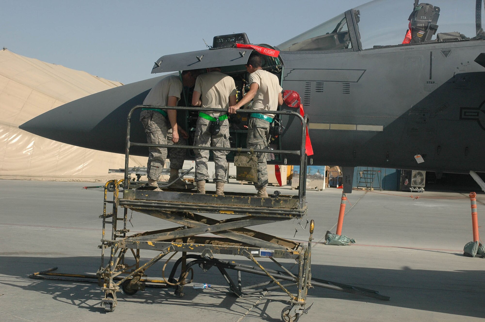 BAGRAM AIRFIELD, Afghanistan -- Three crew chiefs work to fix a mechanical problem on an F-15E Strike Eagle, Sept. 22, here. The crew knew the aircraft needed maintenance from a report provided by an F-15E controller with the 4th Maintenance Operations Center. (U.S. Army photo/U.S. Army Pfc. Cody A. Thompson)
