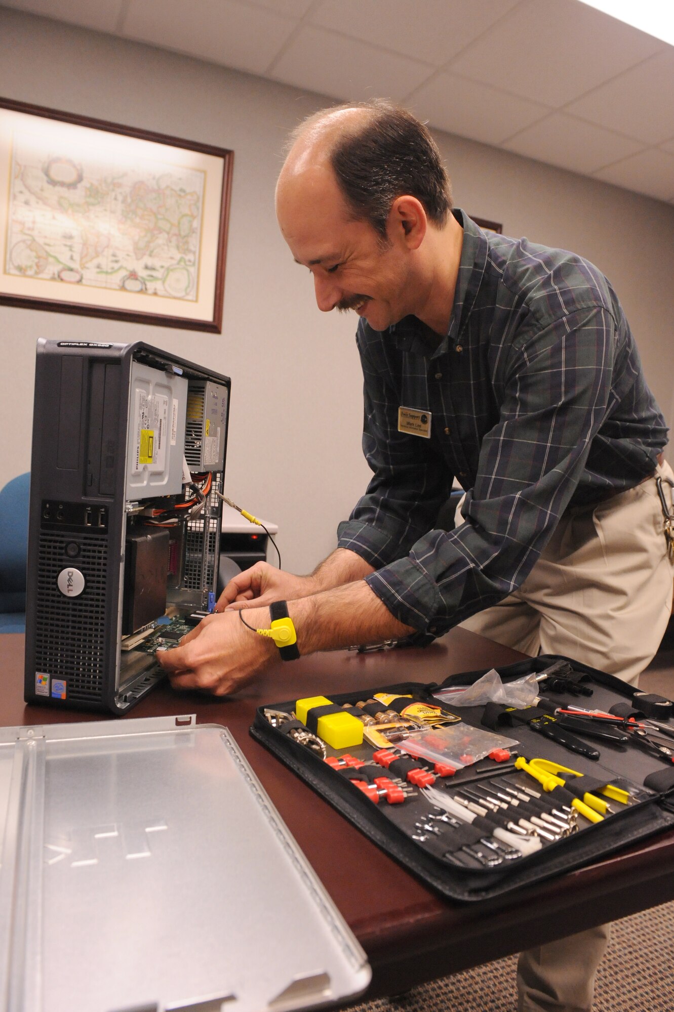 Mark Lee, 4th Force Support Squadron technical information specialist, inspects computer chips in the base library on Seymour Johnson Air Force Base, N.C., Sept. 23, 2009. Mr. Lee has worked at the base library for more than eight years maintaining and updating computers, sustaining the library Web site. (U.S. Air Force photo by Airman 1st Class Whitney S. Lambert)