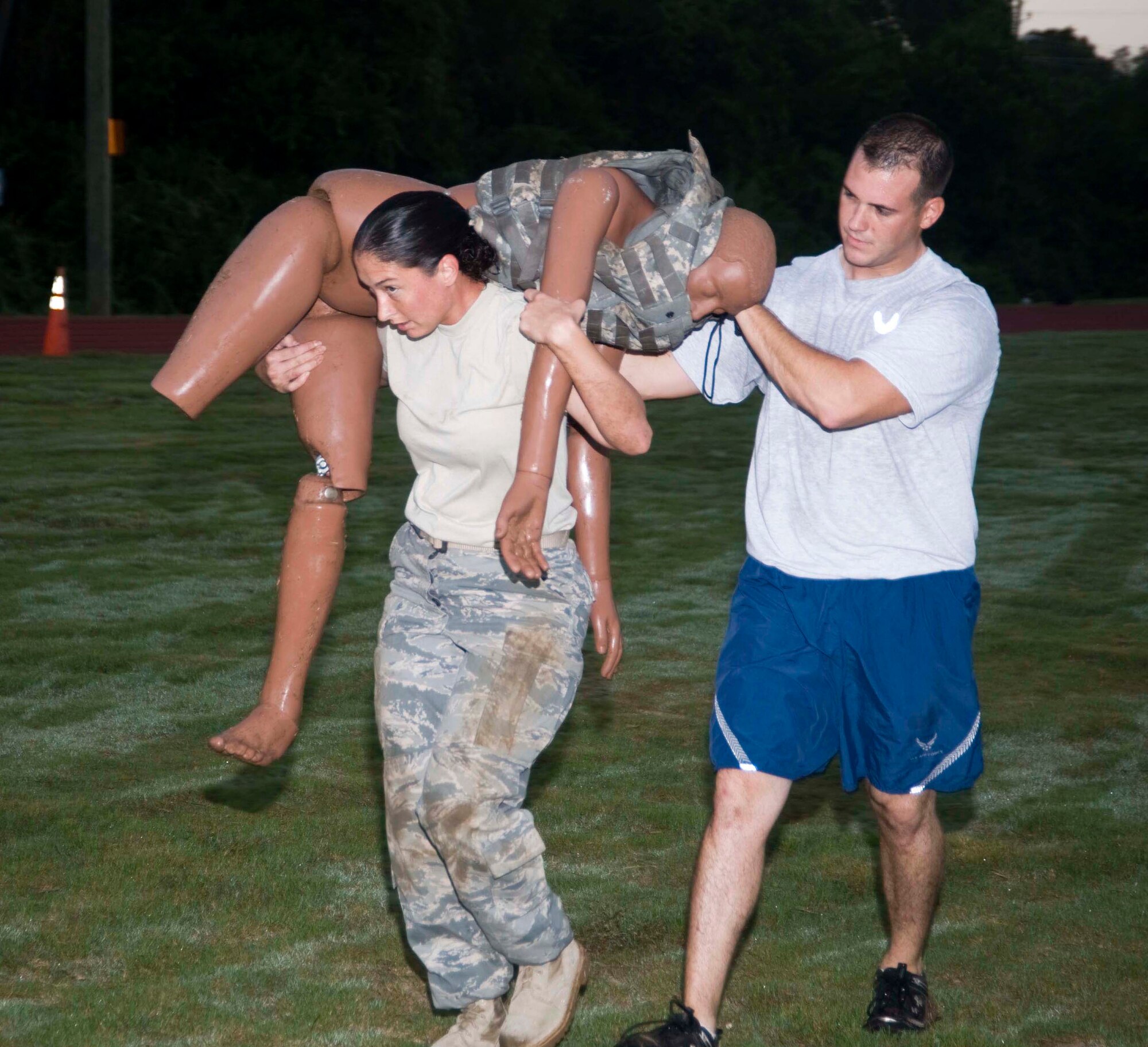 Staff Sgt. Season Kelt carries a dummy while the trainer, Staff Sgt. Leonard Anderson, assists during the 96th Security Forces' Warrior Fit Test. (USAF photo/Wendell Rowan) 
