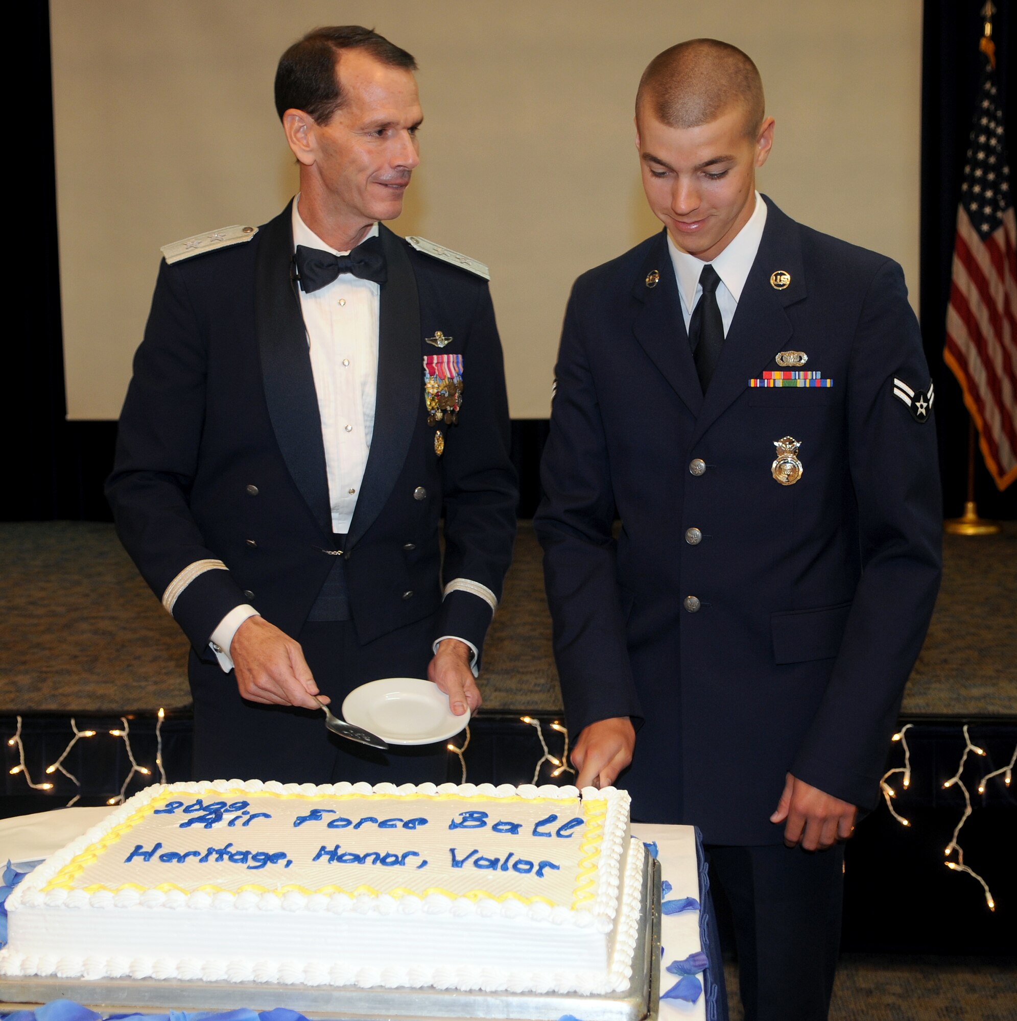 Maj. Gen. Stanley E. Clarke III, the U.S. European Command Chief of the Office of Defense Cooperation in Turkey, and Airman 1st Class Philip Hines, 39th Security Forces Squadron, make the first cuts in the Air Force Ball cake Friday, Sept. 25, 2009, at Incirlik Air Base, Turkey. In line with Air Force tradition, the longest serving Airmen and the Airmen with the shortest time in service cut the cake together.(U.S. Air Force Photo/Senior Airman Alex Martinez)