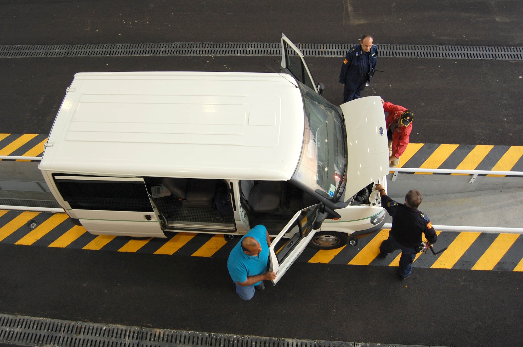 Vigile Sangiorgio security personnel inspect a contractor vehicle at the Large Vehicle Inspection Station Sept. 28, 2009 before allowing the driver access to Aviano Air Base, Italy. The station officially opened this week after nearly two years of construction. (U.S. Air Force photo/Staff Sgt. Lindsey Maurice)