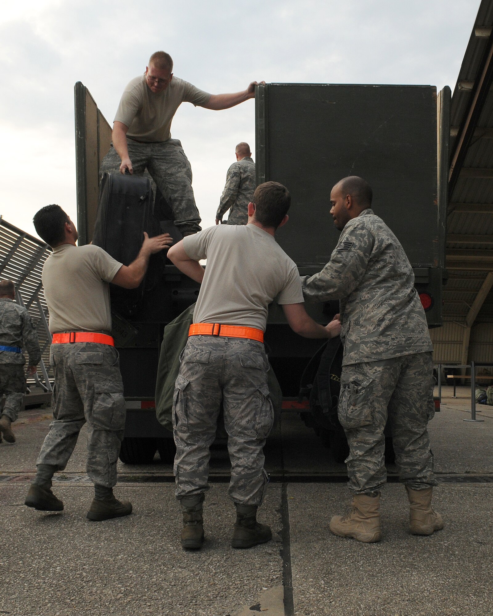 SPANGDAHLEM AIR BASE, Germany - Members of the 52nd Aircraft Maintenance Squadron unload baggage in preparation for a customs inspection Sept. 28 after returning from a four-month deployment to Joint Base Balad, Iraq. The 52nd AMXS deployed in support of the 22nd Fighter Squadron, which flew nearly 1,500 sorties and logged more than 6,000 hours of flight time in support of Operation Iraqi Freedom. (U.S. Air Force photo/Airman 1st Class Nathanael Callon)