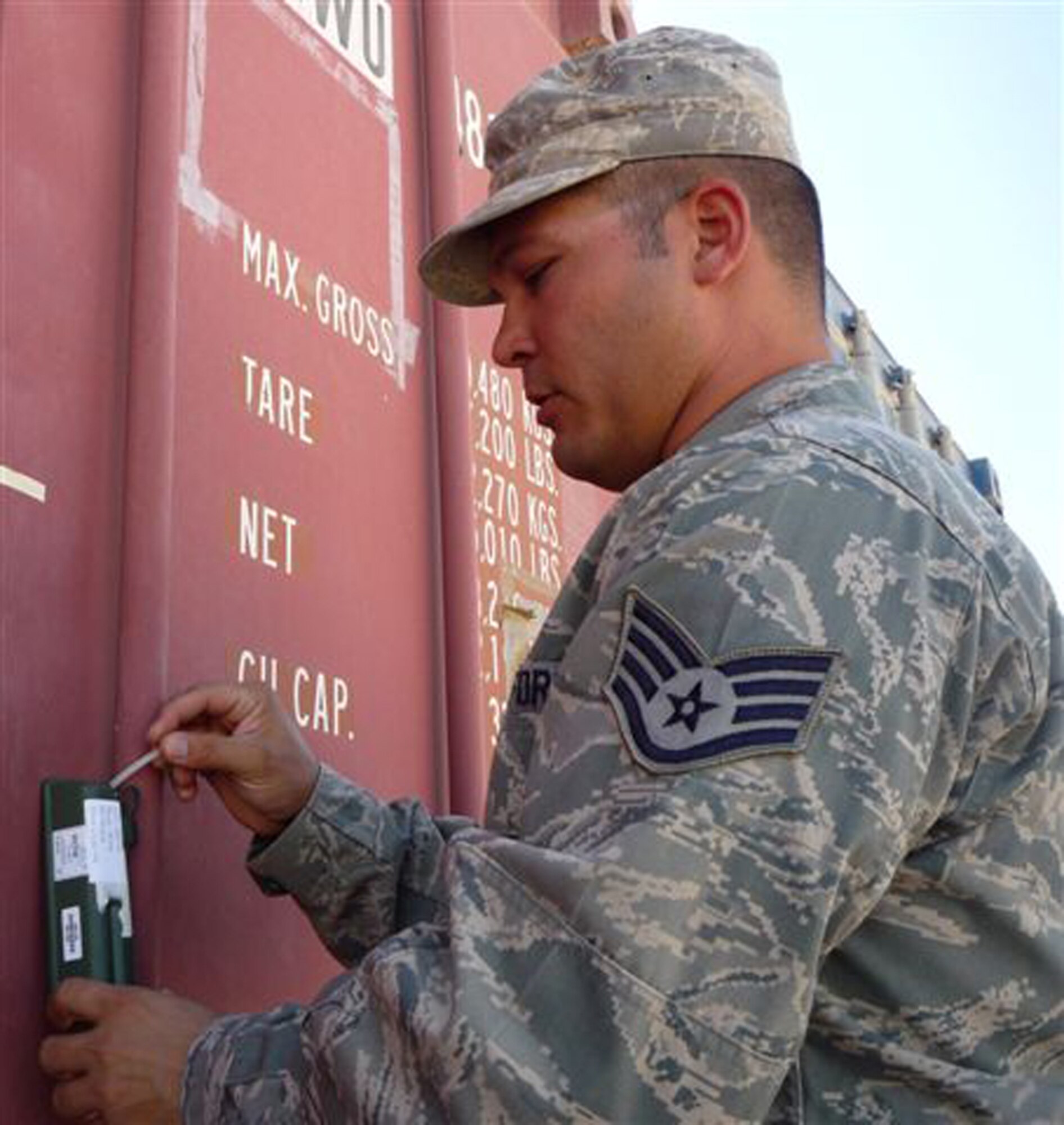 CAMP BUCCA, Iraq -- Staff Sgt. Will Engle, 732nd Movement Control Team Joint Distribution Center NCO in charge, affixes a radio frequency identification tag to a shipping container Sept. 27, 2009, before a movement out of Camp Bucca, Iraq. Sergeant Engle is deployed from the 436th Aerial Port Squadron at Dover Air Force Base, Del. (Photo by Army Sgt. Mark Berken)