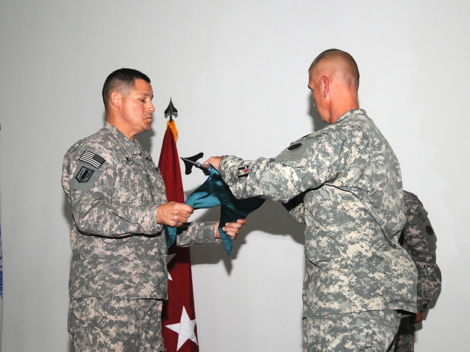 Col. Gary R. Hisle Jr., 1st Battlefield Coordination Detachment commander and Sgt. Maj. Thomas C. Reitmeier, 1 BCD sergeant major unfurl the unit guidon at a ceremony representing the unit's assumption of authority here, Sept. 27. The 1 BCD provides the required support for the integration of land and air operations in Southwest Asia while assigned to the Combined Air and Space Operations Center here. (U.S. Air Force Photo/Tech. Sgt. Jason W. Edwards)