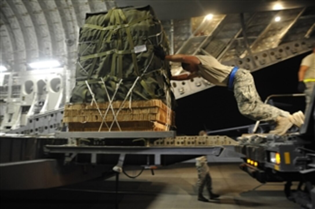 U.S. Air Force Airman 1st Class Andrew Dasilva, a ramp service specialist with the 8th Expeditionary Aircraft Maintenance Squadron, loads container delivery system bundles onto a C-17 Globemaster III aircraft at a base in Southwest Asia on Sept. 23, 2009.  The container delivery system bundles, full of supplies for Marines, will be dropped off at a base in Afghanistan.  