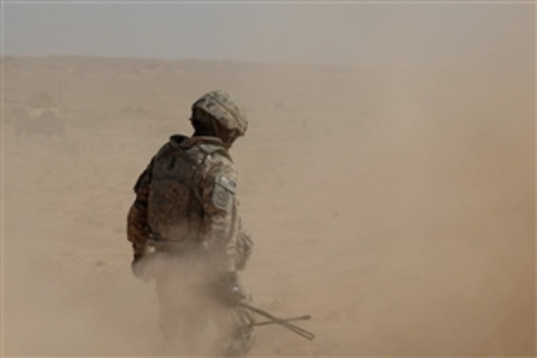 A U.S. soldier from 1st Platoon, Charlie Company, 9th Engineer Battalion, braves a cloud of dust during operations near the Iraq-Iran border, Sept. 22, 2009.  