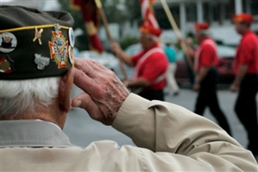 Joseph Kovac, a retired sailor and Veterans of Foreign Wars past commander, salutes one of many color guards in the John Basilone Parade in Raritan, N.J., Sept. 27, 2009. The parade, the largest military parade in the nation, honors Basilone, a Marine gunnery sergeant native to the town, who received a Medal of Honor and the Navy Cross for actions in Guadalcanal and Iwo Jima.