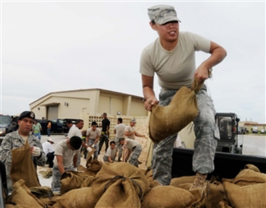 U.S. Air Force Airman 1st Class Jolene Muna, from the 254th Security Forces Squadron, Guam Air National Guard, loads sandbags onto a truck at Andersen Air Force Base, Guam, to prepare for a possible tropical storm headed for the island on Sept. 28, 2009.  