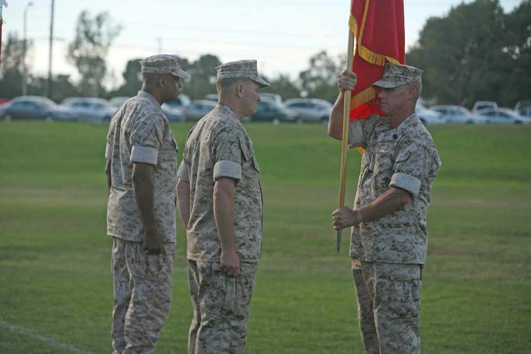 Sgt. Maj. Jeffrey H. Dixon, sergeant major of Marine Corps Installations West, hands over the colors to Maj. Gen. Michael R. Lehnert, who relinquished command to Maj. Gen. Anthony L. Jackson during the MCIWEST change of command ceremony, Sept. 29, at Marine Corps Base Camp Pendleton.
