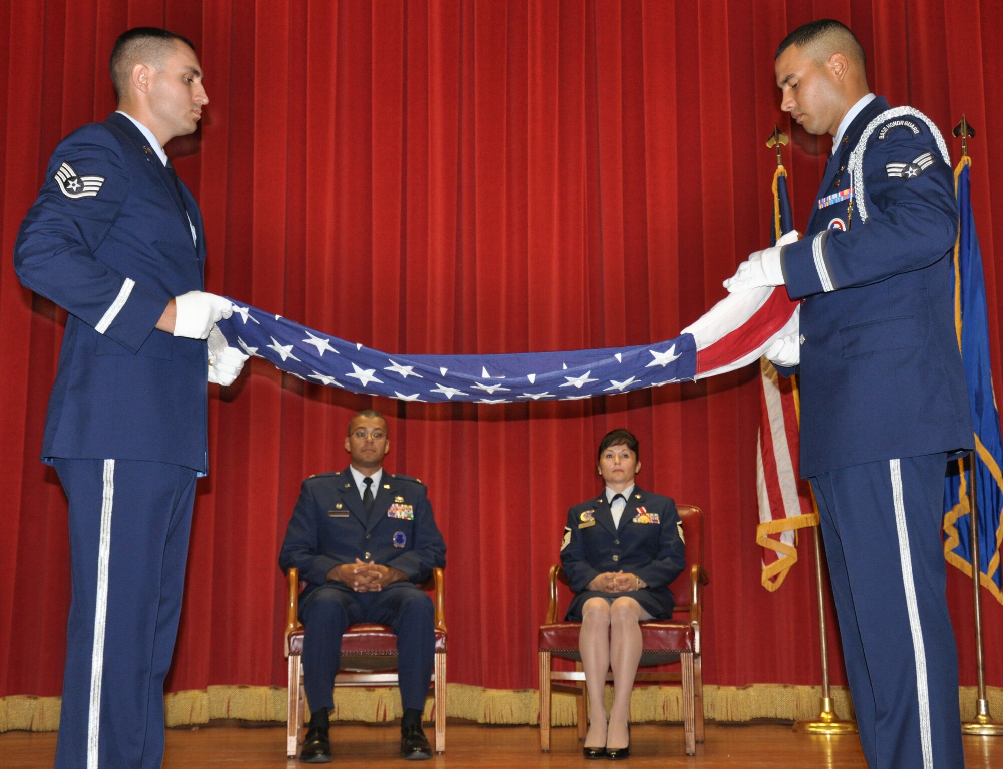 Col. Joe N. Wilburn, AFRC recruiting commander,and retiring Master Sgt. Darlene S. Leyva, a health professions recruiter, watch (left to right) Staff Sgt. Estevan Vigil, 216 OSS, Vandenberg AFB and Senior Airman Michael D. Arriaga, 452 FSS, March ARB fold the flag to commemorate Sergeant Leyva’s 22 years of service to the Air Force in the Cultural Resources Center. (U.S. Air Force photo by Staff Sgt. Megan Crusher)