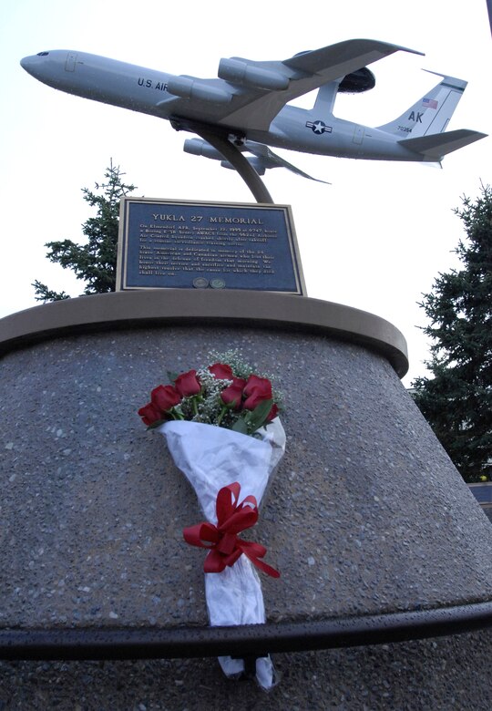 ELMENDORF AIR FORCE BASE, Alaska -- A bouquet of flowers was presented by the Japan Air Self-Defense Force members as they paid their respects to the Yukla 27 Memorial here Sept. 30. Yukla 27 was the callsign for Elmendorf's AWACS that crashed Sept. 22, 1995, less than a mile away from the runway. The JASDF E-767 AWACS crew is here to participate in Red Flag-Alaska 10-1. (U.S. Air Force photo/Senior Airman David Carbajal)