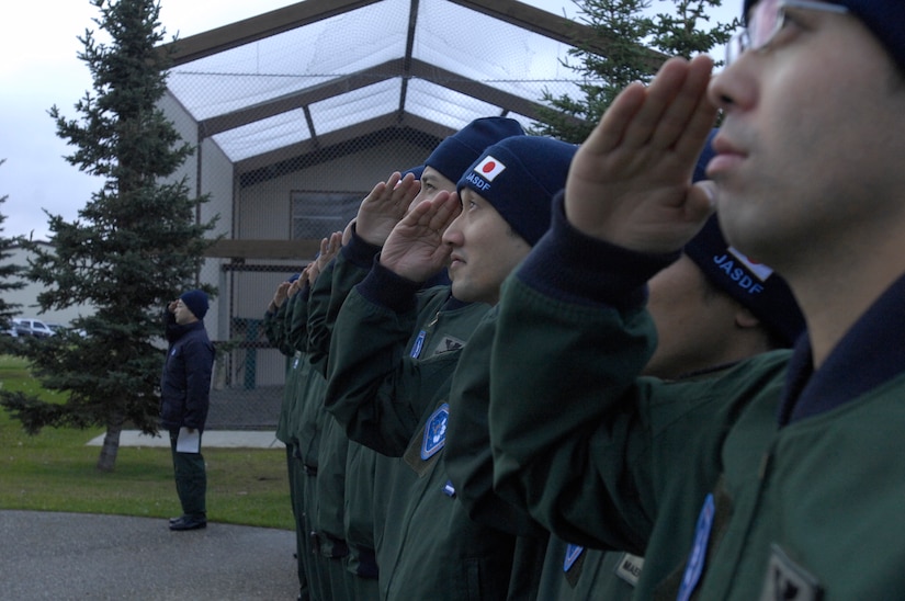 ELMENDORF AIR FORCE BASE, Alaska -- Japan Air Self-Defense Force members pay their respects to the Yukla 27 Memorial here during a ceremony Sept. 30. Yukla 27 was the callsign for Elmendorf's AWACS that crashed Sept. 22, 1995, less than a mile away from the runway. The JASDF E-767 AWACS crew is here to participate in Red Flag-Alaska 10-1, which takes place Oct. 5-16. (U.S. Air Force photo/Senior Airman David Carbajal)