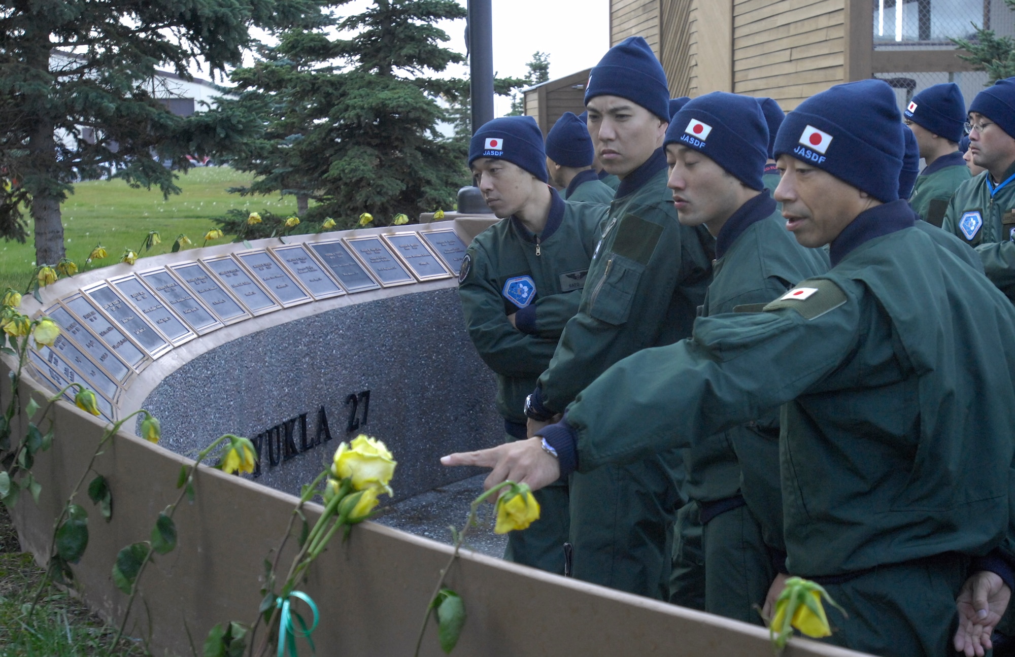 ELMENDORF AIR FORCE BASE, Alaska -- Japan Air Self-Defense Force members look at the names of fallen servicemembers who were killed in the Yukla 27 AWACS crash Sept. 22, 1995, here. The JASDF E-767 AWACS crew is here to participate in Red Flag-Alaska 10-1, which takes place Oct. 5-16. (U.S. Air Force photo/Senior Airman David Carbajal)