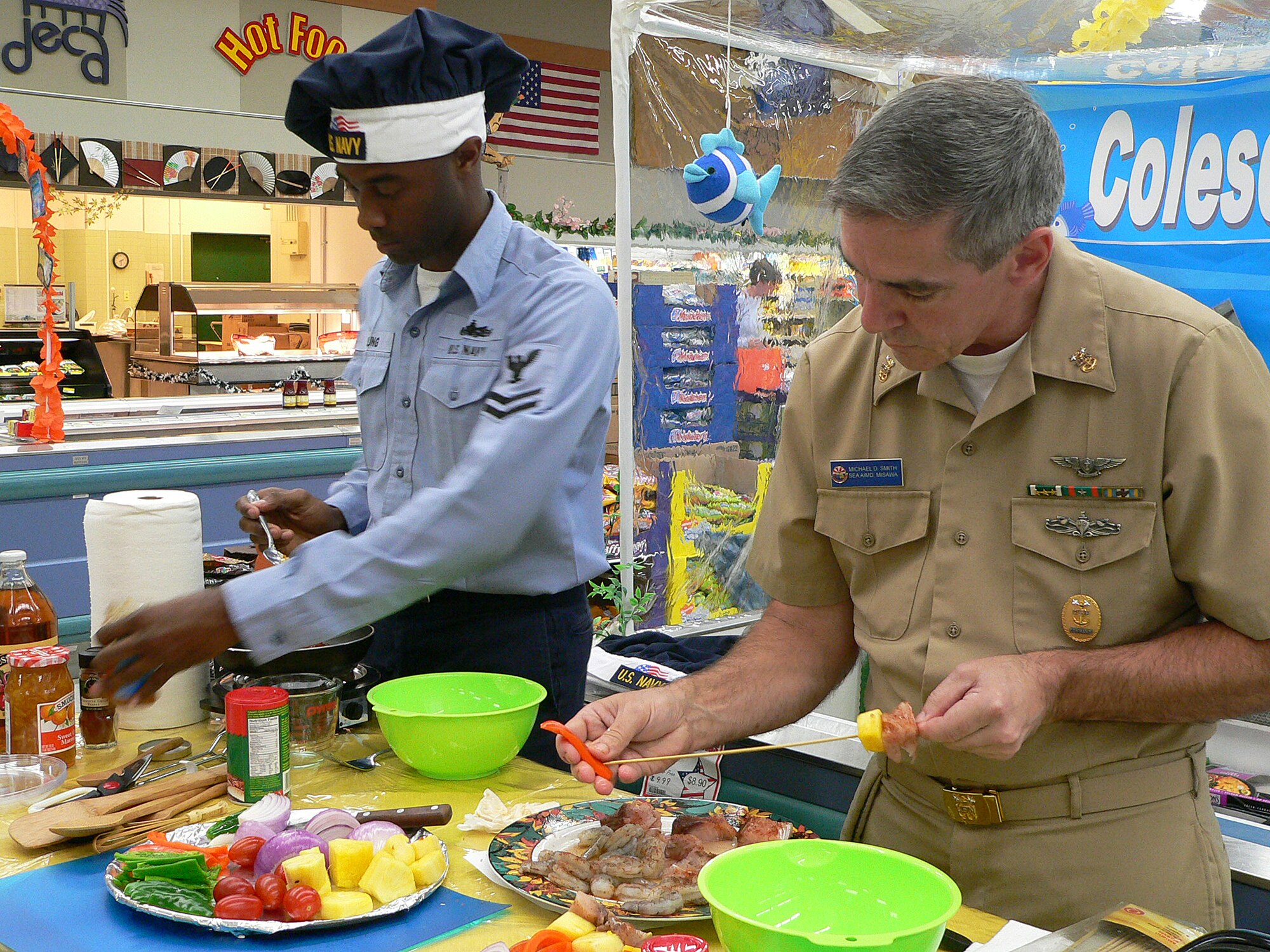 Misawa Air Base, Japan -- Petty Officer 2nd Class Jermaine Young stirs while Master Chief Petty Officer Mike Smith, with the Aircraft Intermediate Maintenance Detachment Misawa, puts vegetables on skewers during the Armed Forces cook-off Sept. 27. Competitors could bring their own tools but all ingredients had to be found in the commissary. (Photo/Mrs. Satsue Sasaki)