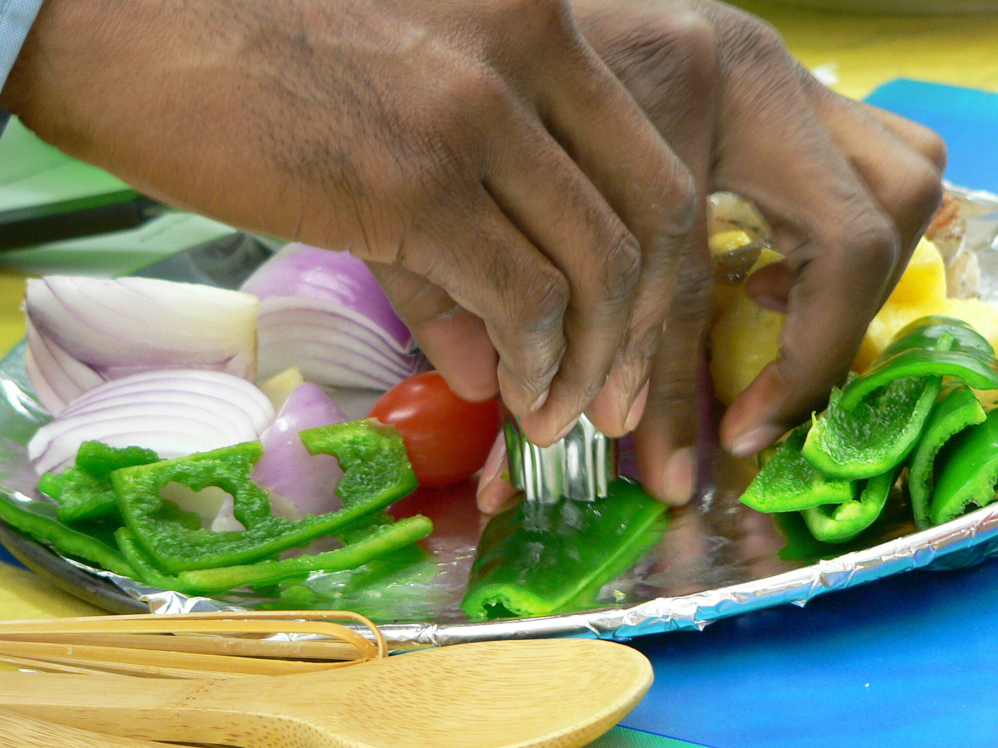 Petty Officer 2nd Class Jermaine Young, Aircraft Intermediate Maintenance Detachment Misawa, cuts shapes out of vegetables for skewers put together for the Armed Forces cook-off at the commissary Sept. 27. In addition to being judged on appearance and taste, contestants’ dishes were judged on preparation, which includes how long it takes and how simple it is to prepare. (Photo/Mrs. Satsue Sasaki)