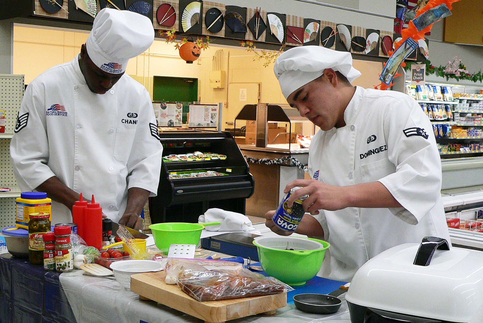 Misawa Air Base, Japan -- Staff Sgt. Joseph Chaney and Airman 1st Class Frank Dominguez, with the 35th Force Support Squadron Grissom Dining Facility, slice and prepare a black bean salsa during the Armed Forces cook-off Sept. 27. The Air Force team soared by the Navy with a win. (Photo/ Mrs. Satsue Sasaki)