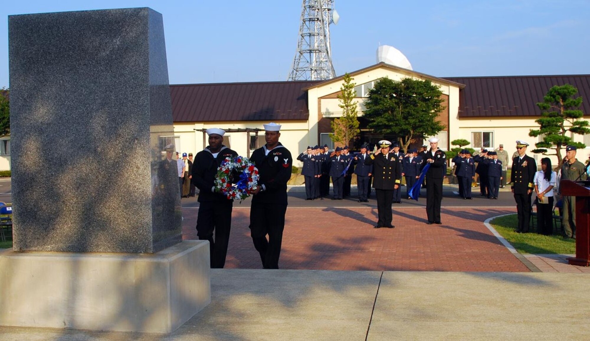 Petty Officer 2nd Class George Collins and Petty Officer 2nd Class Taurean Hunt lay a wreath in honor of all Prisoners of War and those Missing in Action during a POW/MIA ceremony hosted by Naval Air Facility Misawa Sept. 18. Navy Capt. J.D. Haugen, commander of NAF Misawa, was the guest speaker. The event was attended by the Navy, Air Force, Japan Air Self-Defense Force and military veterans. (U.S. Navy photo/Petty Officer 2nd Class Matthew M. Bradley)