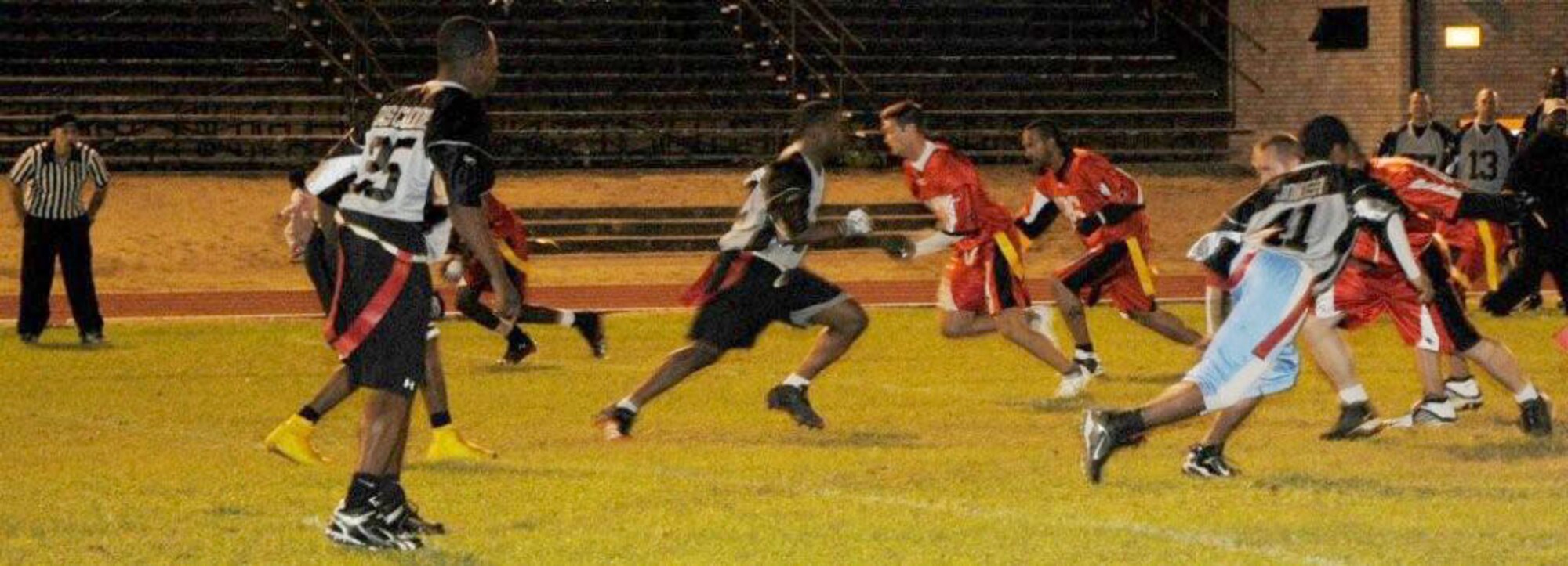 The Logistics Readiness Squadron and Medical Group intramural flag football teams sprint their routes as the ball is snapped Sept. 29, 2009, at RAF Lakenheath, England. The Logistics Readiness Squadron won the contest 15-14. (U.S. Air Force photo/Airman 1st Class Knox)