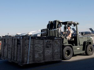 Senior Airman Joshua Vogann drives a forklift to transport a crate carrying a C-17 nose radome on the flightline here Sept. 30. The damaged nose radome was transported to the Flightline Support Facility for repair processing. Senior Airman Vogann is a C-17 crew chief with the 437th Aircraft Maintenance Squadron. (U.S. Air Force photo/Staff Sgt. Daniel Bowles)