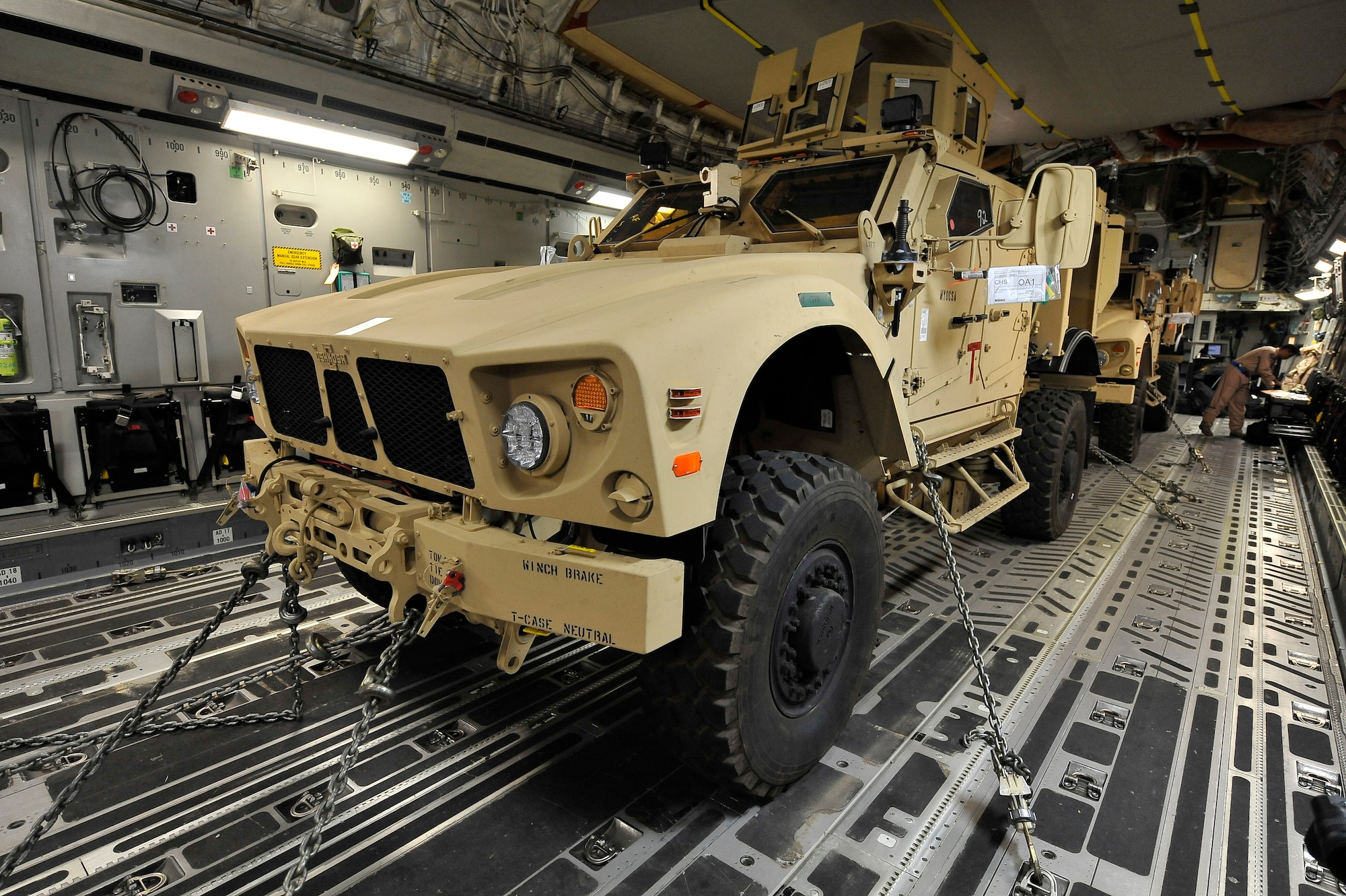 Two mine-resistant, ambush-protected all-terrain vehicles, or M-ATVs, await transport on a C-17 Globemaster III at Charleston Air Force Base, S.C., Sept. 30, 2009.  The two M-ATVs are the first to be delivered to the Afghanistan theater for operational use. The C-17 is based out of McChord AFB, Wash. (U.S. Air Force photo/James M. Bowman)