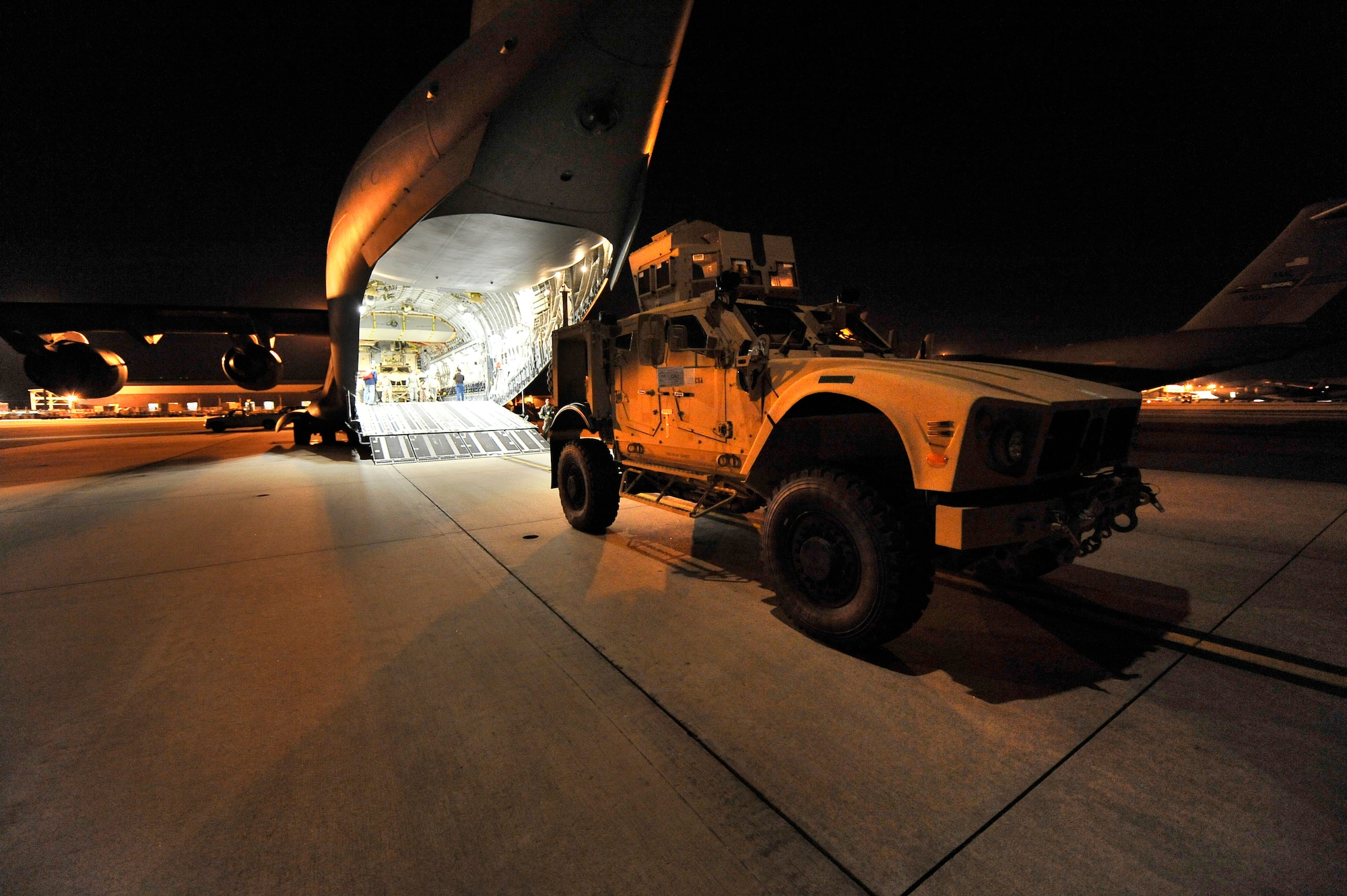 One of two mine-resistant, ambush-protected all-terrain vehicles, or M-ATVs, is loaded onto a C-17 Globemaster III at Charleston Air Force Base, S.C., Sept. 30, 2009.  The two M-ATVs are the first to be delivered to the Afghanistan theater for operational use.  The C-17 is based out of McChord AFB, Wash. (U.S. Air Force photo/James M. Bowman)
