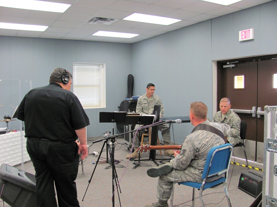 Members of Top Flight, MSgt Tony DeLuzio, TSgt Steve Wilson and A1C Lambert work with Classical Spotlight host, John Clare.