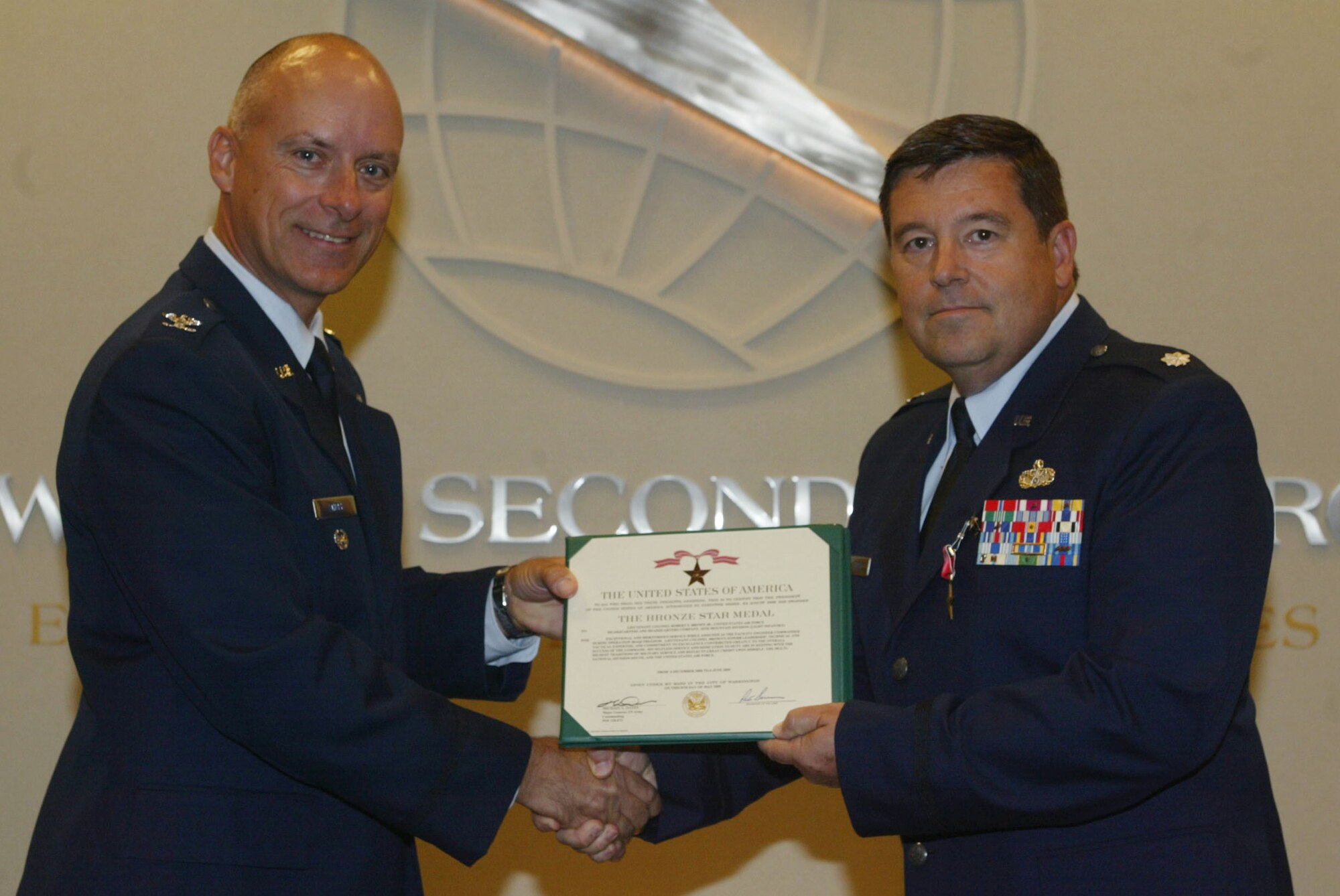 Col. Jon Andre, vice commander, Headquarters 22nd Air Force presents the Bronze Star Medal to Lt. Col. Robert (Stan) Brown for exceptional and meritorious service while assigned as a facility engineer commander during Operation Iraqi Freedom Sep. 13. (U.S. Air Force photo/Don Peek)