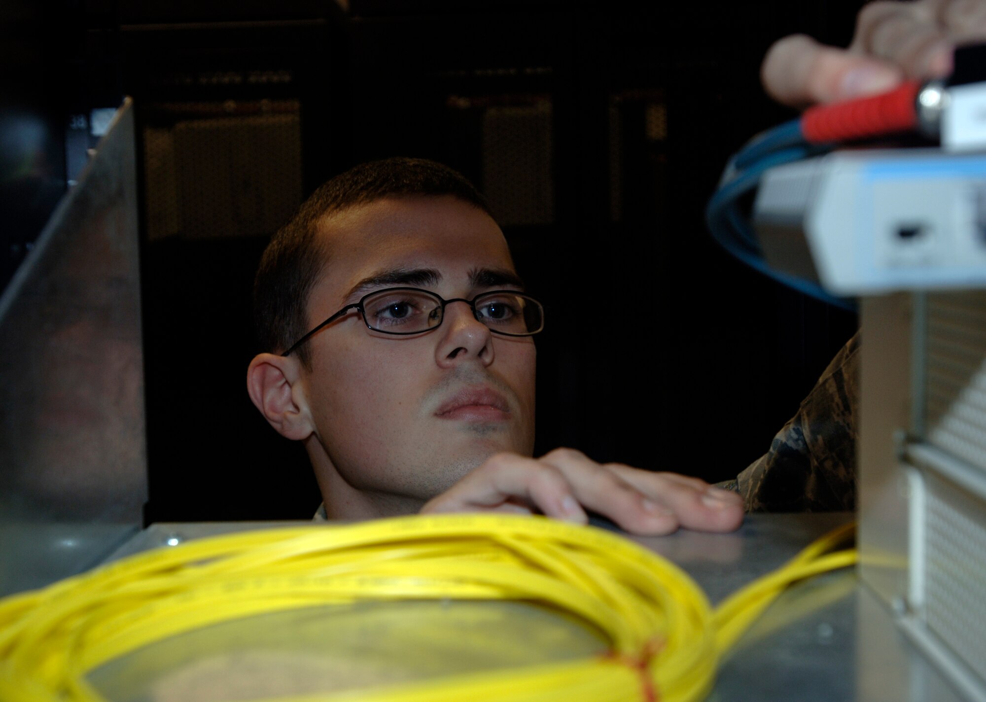 Airman 1st Class Michael J. Roy, 319th Communications Squadron, works on some equipment Sept. 30 in building 242 on Grand Forks Air Force Base, N.D. Airman Roy was named the stateside "Node Site Coordinator of the Year" by the Defense Information System Agency. (U.S. Air Force photo by Senior Airman R. Michael Longoria)