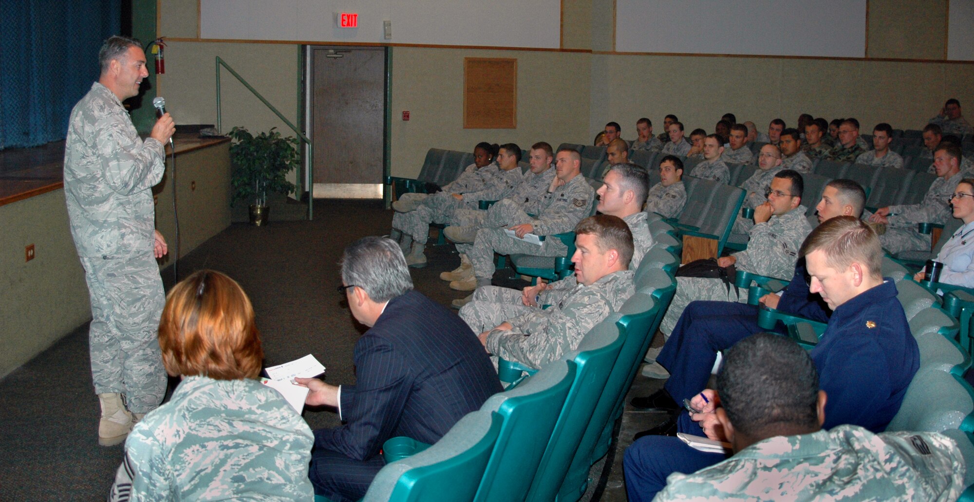 Col. Leslie Hargett, Air Force Personnel Command "Spread the Word" briefing team member, speaks to Malmstrom Airmen and civilian employees about AFPC programs during a mass briefing Sept. 29 at the base theatre. (U.S. Air Force photo/Senior Airman Dillon White)