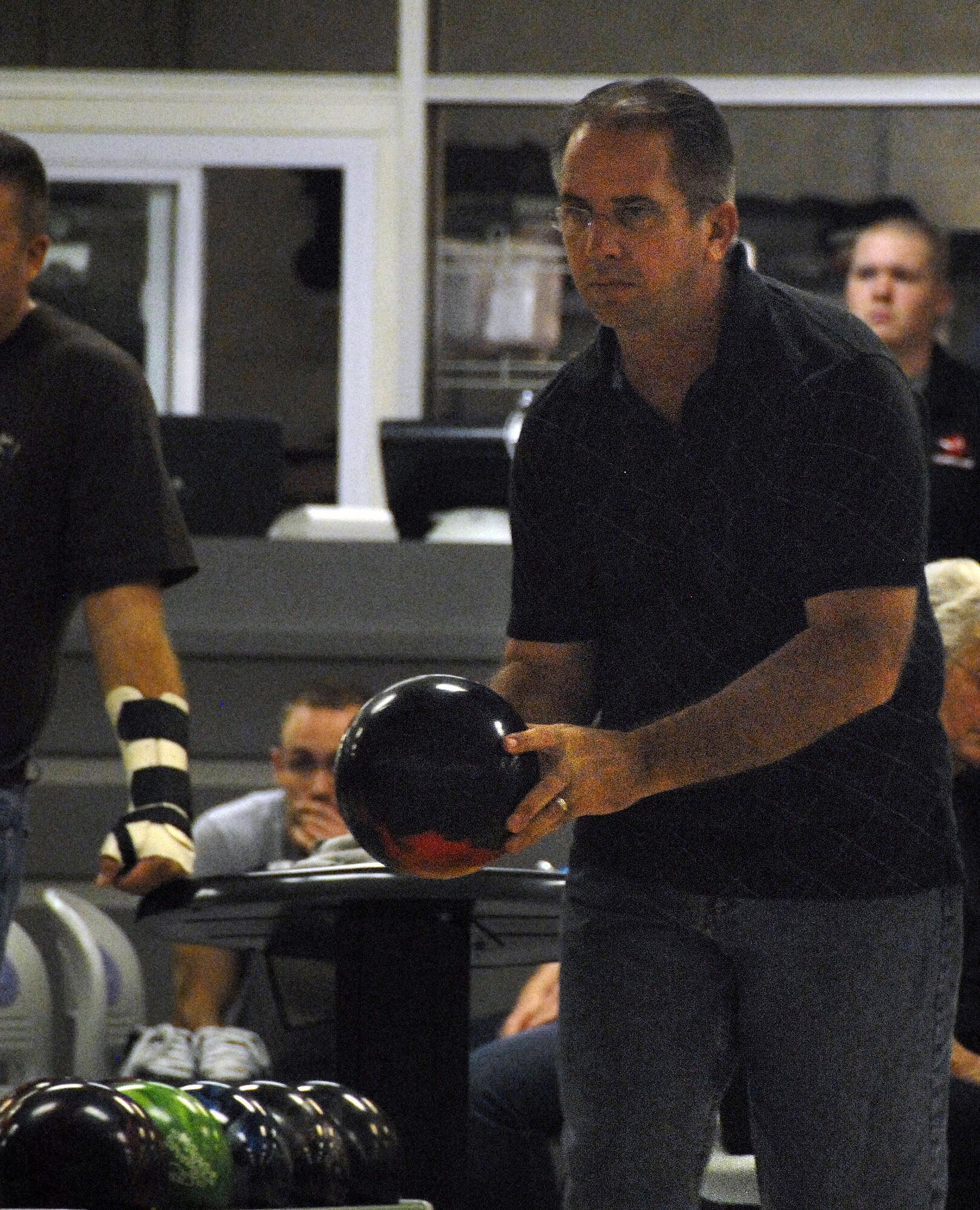 Dave Shuff lines up is aim as he prepares to bowl during a League Bowling game at the Starlifter Lanes here Sept. 25. Mr. Shuff's team competed against the team in the adjacent lane and was defeated by three points. Mr. Shuff is a retired master sergeant. (U.S. Air Force photo/Staff Sgt. Daniel Bowles)