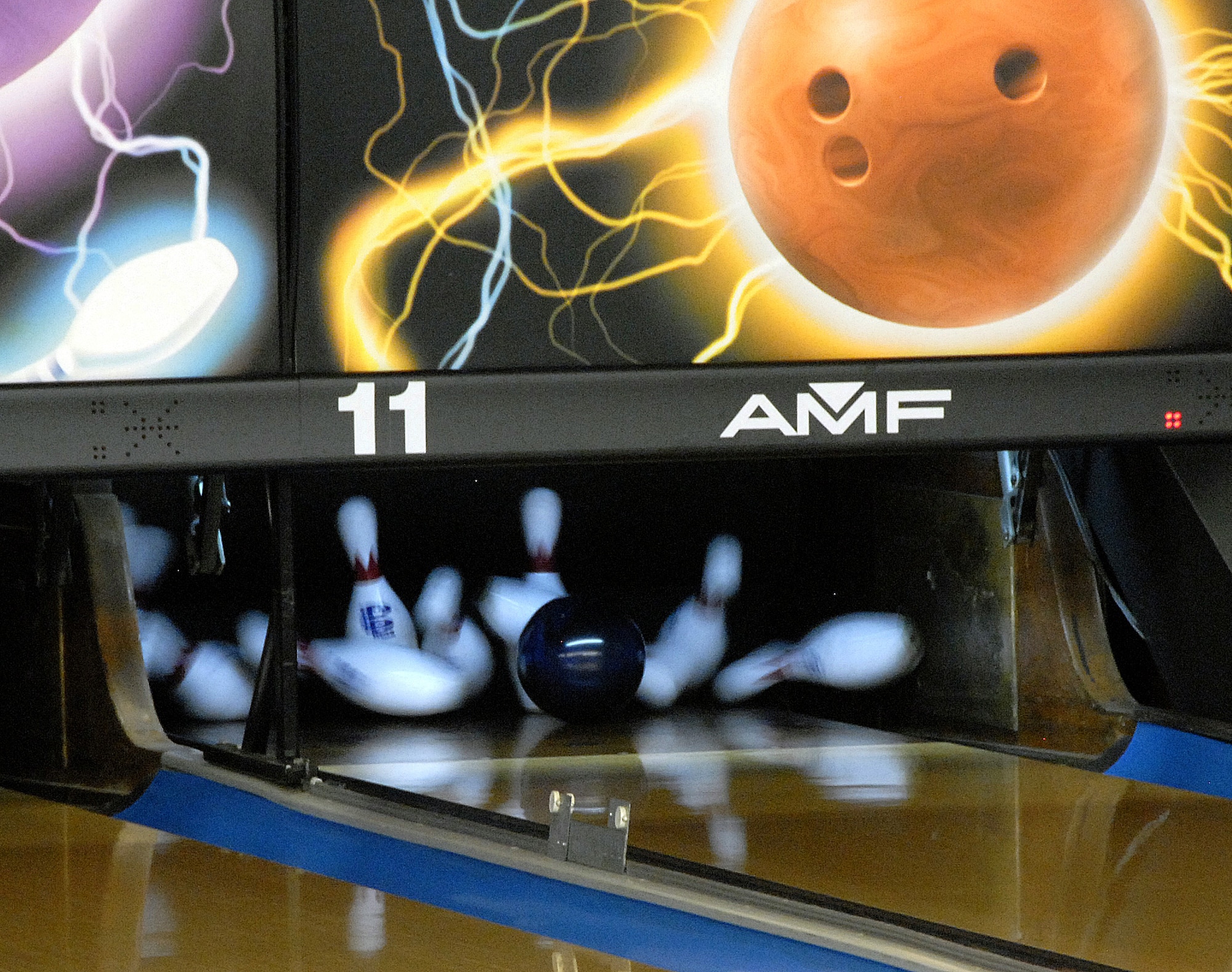 A league bowler gets a strike for their team during League Bowling night at the Starlifter Lanes here Sept. 25. The  League Bowling season begins each year in September and lasts until May. (U.S. Air Force photo/Staff Sgt. Daniel Bowles)
