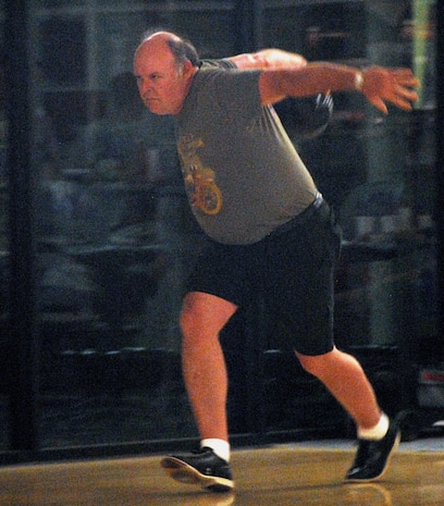 Dee Coulter puts speed in his step as he prepares to bowl during League Bowling night at the Starlifter Lanes here Sept. 25. League teams are comprised of four bowlers who compete against opponents using a combined total score. Mr. Coulter is a retired master sergeant. (U.S. Air Force photo/Staff Sgt. Daniel Bowles)