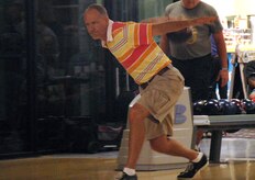 Paul Whittsack prepares to send his bowling ball barreling toward the pins during League Bowling night at the Starlifter Lanes here Sept. 25. His team bowled a total of three games, achieving a average score of 845. Mr. Whittsack is a retired lieutenant colonel. (U.S. Air Force photo/Staff Sgt. Daniel Bowles)