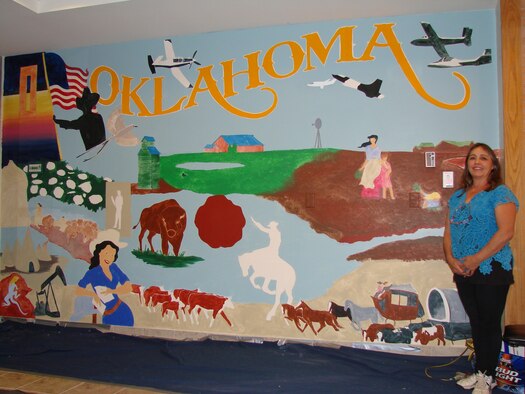 Carol Forsythe, a civilian artist, is painting a mural representing Vance and Oklahoma in the entrance of the base clinic. (U.S. Air Force photo/ 2nd Lt. Christopher Carrillo)