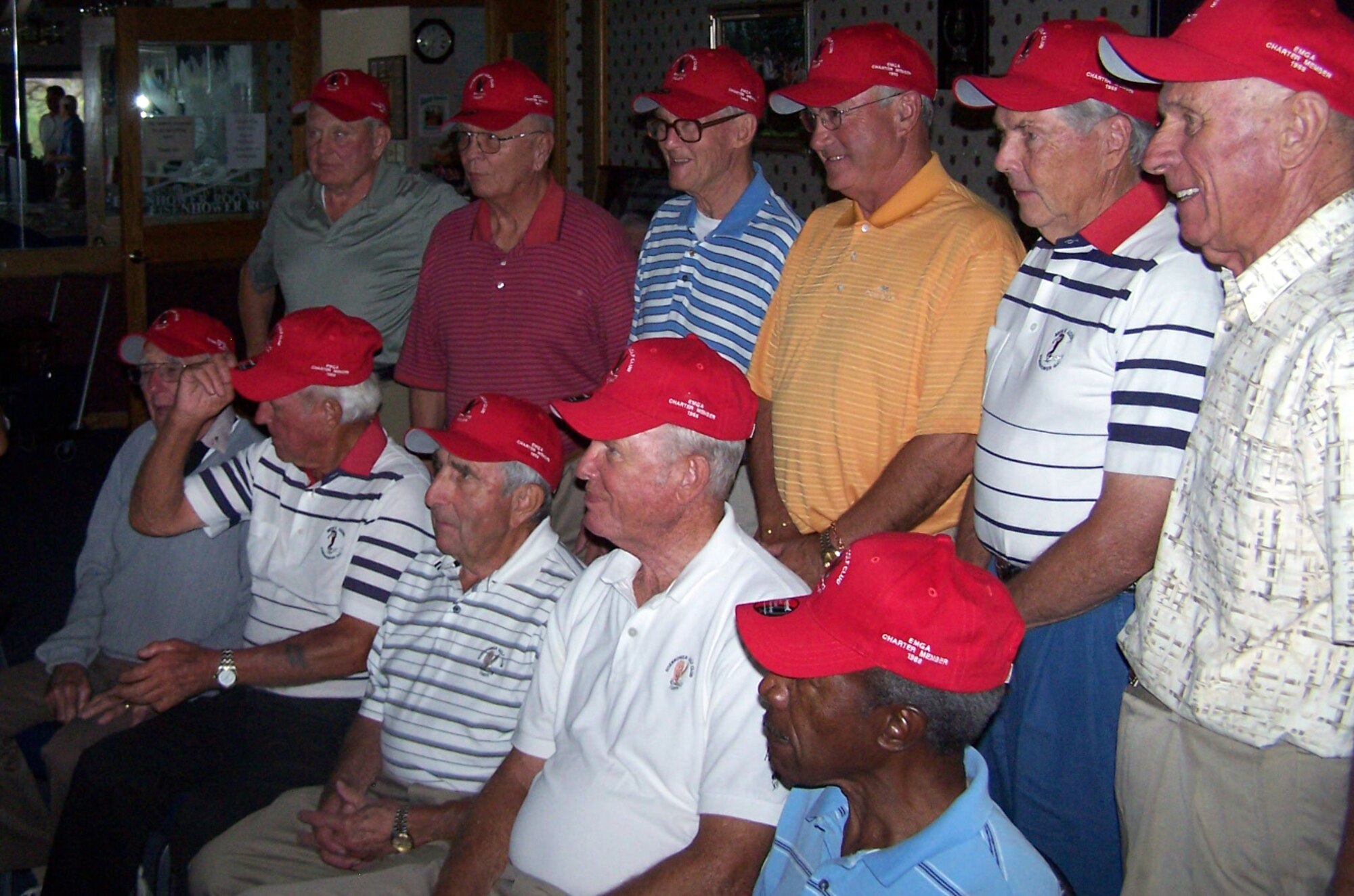 Charter members of the Eisenhower Men's Golf Association pose for a group photo after receiving their red Eisenhower Golf Club hats bearing the label "EMGA Charter Member 1988" at the U.S. Air Force Academy Sept. 17, 2009. Out of 205 original EMGA members, 16 still actively play golf and were recognized at the luncheon for their stamina and continued athleticism. (U.S. Air Force photo/Butch Wehry)