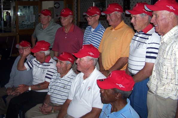 Charter members of the Eisenhower Men's Golf Association pose for a group photo after receiving their red Eisenhower Golf Club hats bearing the label "EMGA Charter Member 1988" at the U.S. Air Force Academy Sept. 17, 2009. Out of 205 original EMGA members, 16 still actively play golf and were recognized at the luncheon for their stamina and continued athleticism. (U.S. Air Force photo/Butch Wehry)