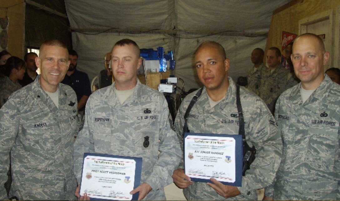 In front of his peers at the 455th ESFS tent, Brig. Gen. Steven Kwast, 455th AEW/CC, personally recognized and coined Airman 1st Class Junior Ramirez for his dedication to duty and real impact he's making in the battlespace. (Left to Right) Brig. Gen. Kwast, another award winner, Airman Ramirez and Chief Master Sgt. Dennis Vannorsdall, 455th AEW Command Chief.
