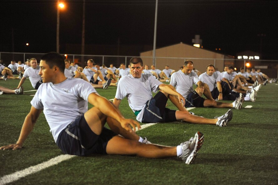 DYESS AIR FORCE BASE, Texas — More than 250 7th Component Maintenance Squadron Airmen warm up for a 5:45 a.m. squadron run on the football field here Sept 30. The team followed the lead of Maj. Jeffery Baldwin, 7 CMS commander, along a pre-determined route. (U.S. Air Force photo by Senior Airman Domonique Washington)