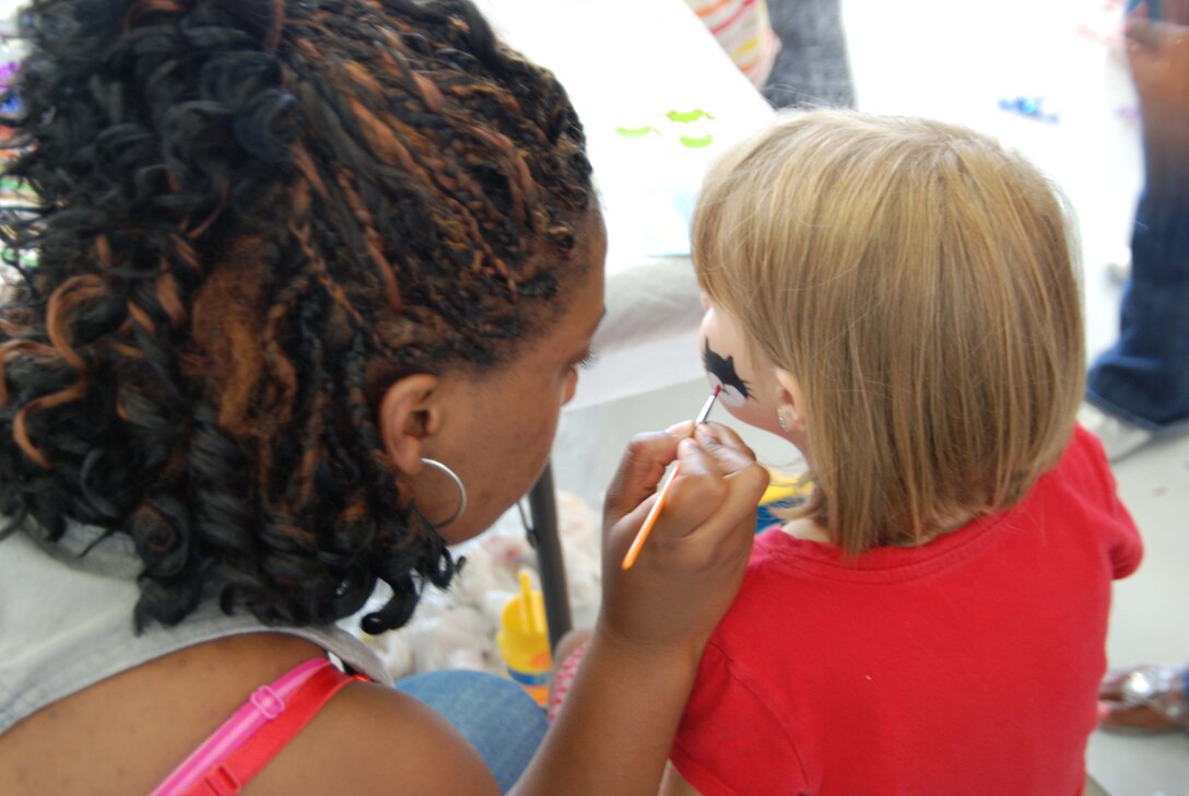 The Airman and Family Readinesss center provided face painting, moon bounce, and children's games at the 459th Air Refueling Wing picnic held in Hangar 10 over the July UTA here. 1,300 reservists and their families attended the event.  (U.S. Air Force photo/Senior Airman Drew Palvino )