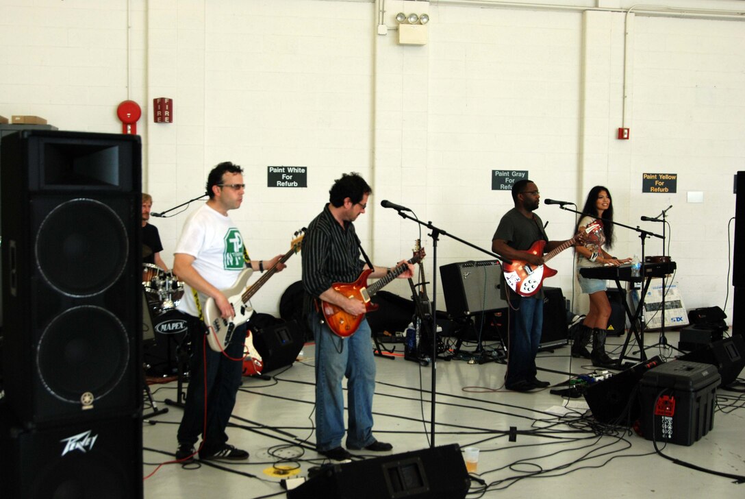 Local band ?Suspicious Package? performs for an audience of 1,300 reservists and their families at the 459th Air Refueling Wing picnic over the July UTA here. The cover band performs throughout the Greater Washington area.  (U.S. Air Force photo/Senior Airman Drew Palvino )