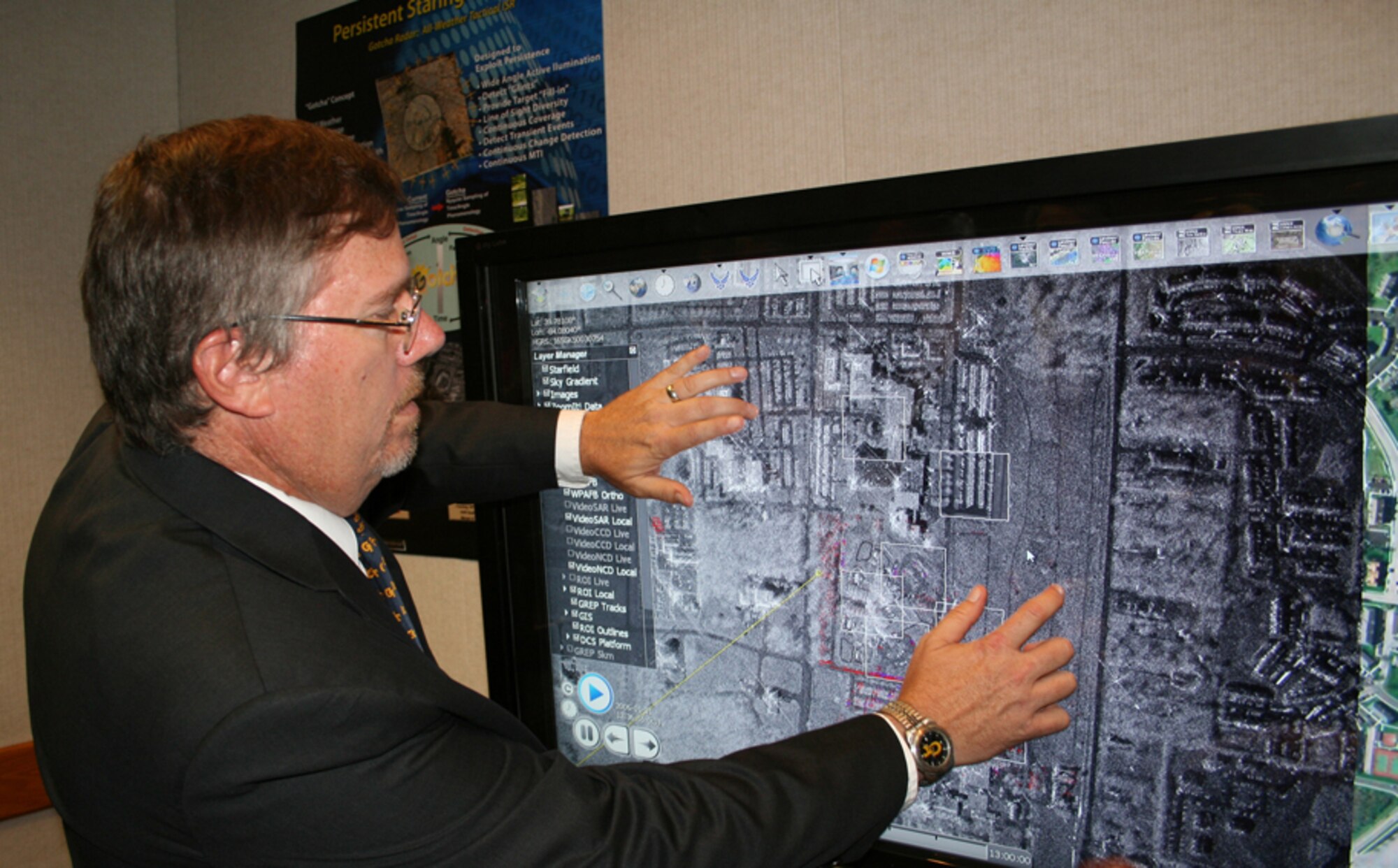 Dr. Michael Minardi uses a touch screen to demonstrate synthetic aperture radar imagery captured during a test of the Gotcha radar system over Wright-Patterson Air Force Base, Ohio. Air Force Research Laboratory researchers are developing Gotcha with the aid of a supercomputer that will translate in real time raw radar data into high-resolution 3-dimensional images. Gotcha is one of portfolio of research efforts to provide enhanced intelligence, surveillance and reconnaissance capabilities to future joint warfighters. Dr. Minardi is Gotcha program manager with AFRL's Sensors Directorate. (Air Force photo/Charles Abruzzino)