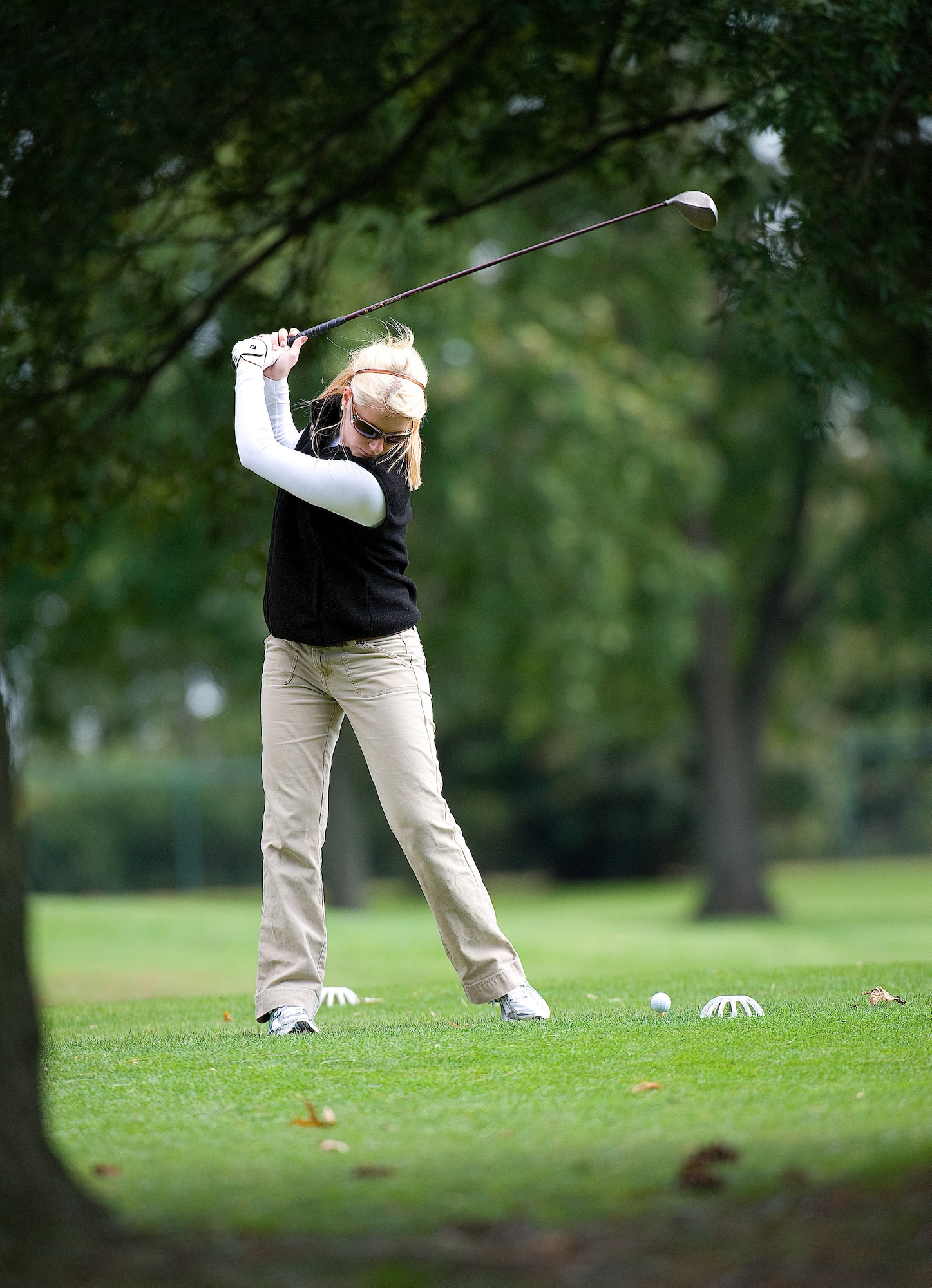 Airman First Class Melissa Kirkbride, 436th Aircraft Maintenance Squadron prepares to tee off during the Bluesuiter's golf tournament Sept. 29 at Eagle Creek Golf Course. Airman Kirkbride had the longest drive of the tournament on the 18th Hole at Eagle Creek. (U.S. Air Force photo by Jason Minto)