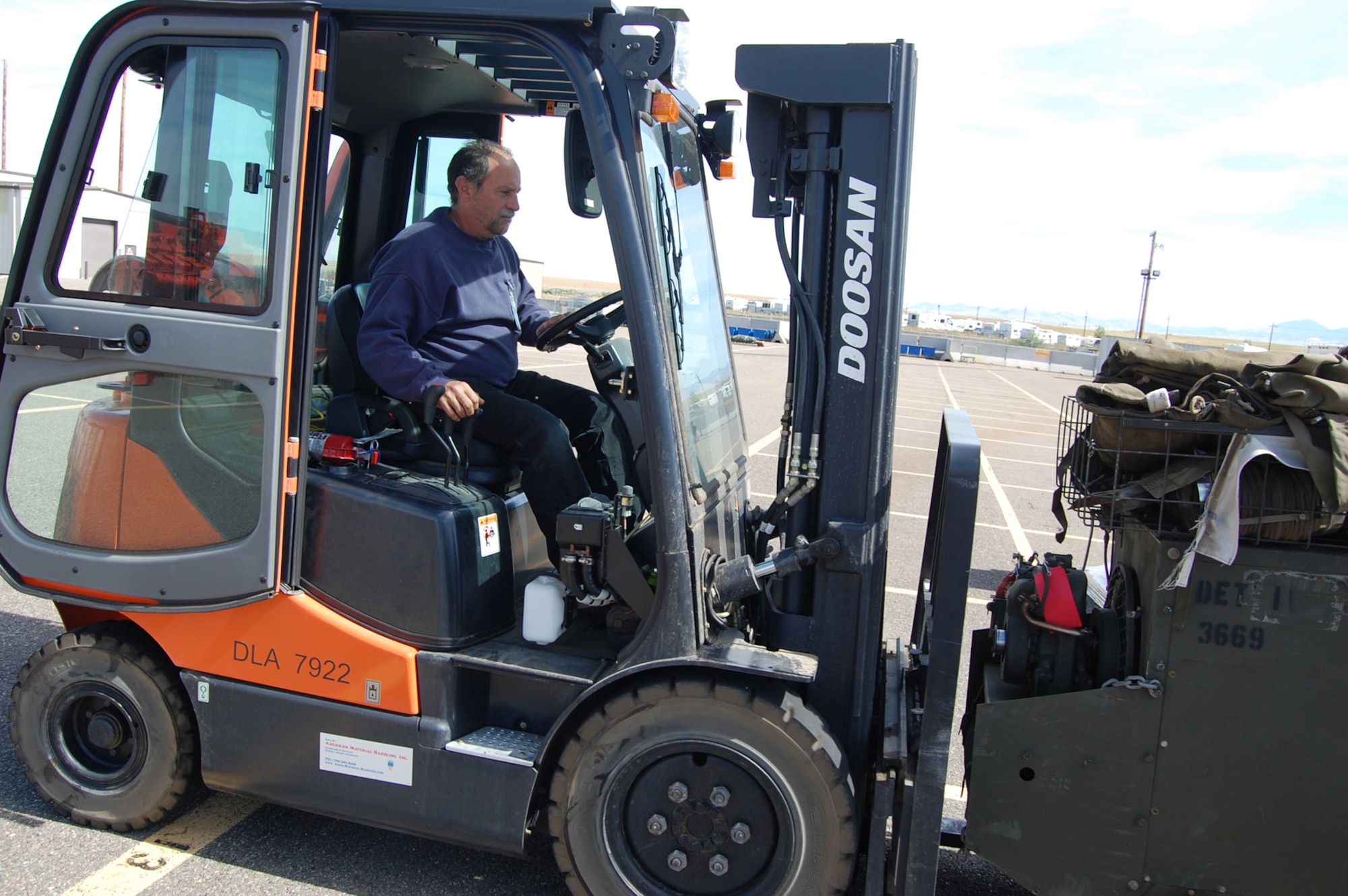 Orlando Parsons, Malmstrom Defense Reutilization and Management Office material handler and identifier, uses a forklift to transport turn-in items. (U.S. Air Force photo/Tech. Sgt. Marcus McDonald)