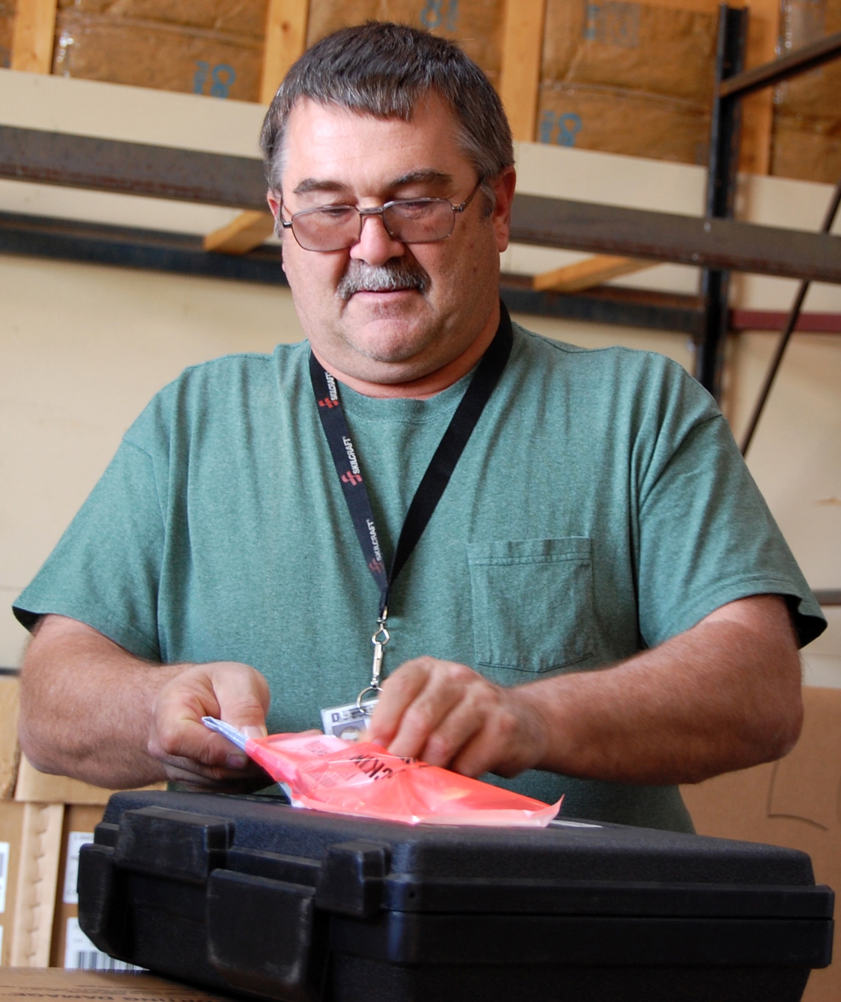 John Reed, Malmstrom Defense Reutilization and Management Office disposal service representative, reviews turn-in documents at one of DRMO's storage areas. (U.S. Air Force photo/Tech. Sgt. Marcus McDonald)